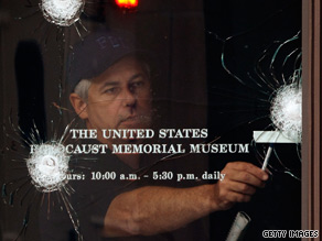 An FBI investigator looks over gunshot holes in the door of the U.S. Holocaust Museum on Thursday.