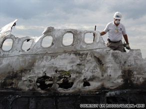 Personal effects are removed from the site of an airline disaster.