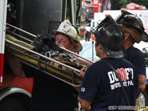 Firefighters climb atop the wreckage of two Metro subway trains that crashed Monday in Washington.