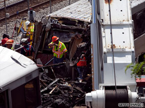 Emergency personnel investigate the scene of the Metro train crash in Washington on Monday.