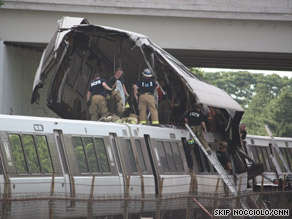 Firefighters climb atop the wreckage of two Metro subway trains that collided Monday in Washington.