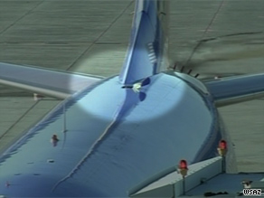 The breach in the aircraft's fuselage caused a loss of cabin pressure. No passengers were injured.