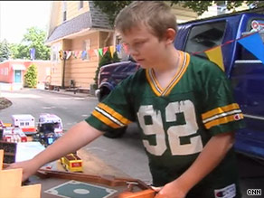 Zach has put a sign out in front of his family's home to attract customers to buy his toys.