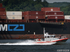 A U.S. Coast Guard vessel passes a container ship in New York Harbor as part of Tuesday's terror drill.
