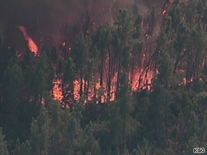 Brush and trees are consumed by flames early Thursday in northern California.
