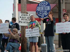 About 50 anti-abortion demonstrators prayed near trucks that showed pictures of dismembered fetuses.