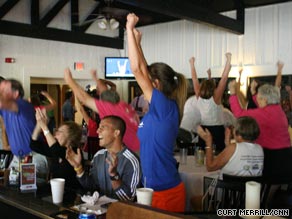 Members of the Racquet Club of the South erupt when Melanie Oudin beats Nadia Petrova.