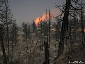 The Station fire continues to spread in California, leaving charred trees in its wake.