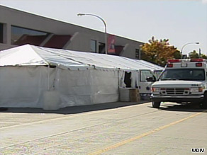 An EMT vehicle is at the scene Sunday in Detroit after three runners collapsed at a marathon.