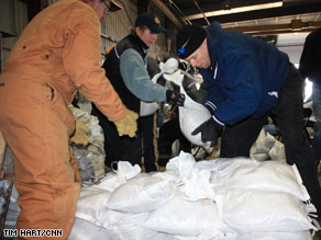 Volunteers at a Fargo, North Dakota, city facility continue to fill and stack sandbags Friday.