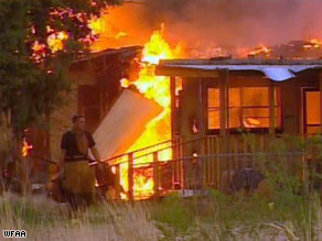 A firefighter sifts through the rubble of a burned home Friday in Midwest City, Oklahoma.