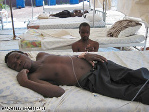 Two men rest in a cholera rehydration tent on the South Africa-Zimbabwe border in December.