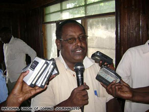 Somalis carry Tahlil's body after he was shot to death in Mogadishu on Wednesday.