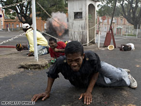 Protesters rally Saturday before violence broke out near the Presidential Palace.