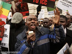 Darfur former student Salah Adam holds a mock-up of al-Bashir in handcuffs at the London vigil.
