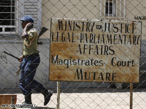 A protester in Mutare, Zimbabwe, holds a sign calling for the release of opposition MDC politician Roy Bennett.