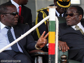 PM Morgan Tsvangirai, left, and President Robert Mugabe attend a funeral for a military commander this week.