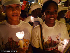 Pilgrims pray on the streets of Luanda on Friday as Pope Benedict XVI begins his visit in Angola.