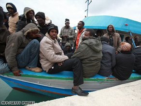 A group of 227 migrants sits on a fishing vessel in Malta last month after arriving from Somalia.