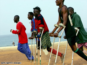 Amputee victims of Sierra Leone's civil war take part in football training at a beach in Freetown.