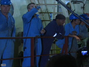 The crew of the Maersk Alabama exchange some words with media after the ship docked in Mombasa, Kenya.