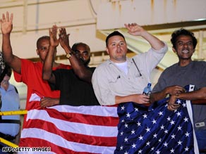 Crew members of the Maersk Alabama celebrate after hearing the Navy had rescued their captain from pirates.