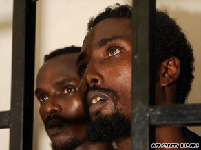 Suspected Somali pirates sit behind bars during the first hearing in their trial at Aden port court on July 15.