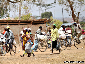 Farmers carry food handouts from the World Food Programme at a distribution spot near Nanyuki.