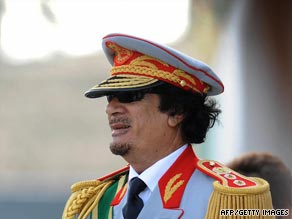 Libyan leader Moammar Gadhafi greets guests Tuesday at a military parade in Tripoli.