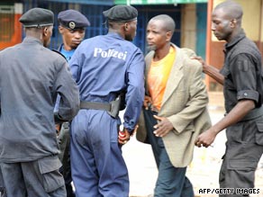 Police arrest a protester on Monday near a stadium in Guinea's capital Conakry during a protest.