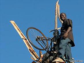 William stands at the top of one of his windmills.