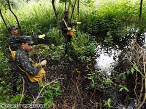 Brazilian soldiers pour insecticide to fight dengue fever in 2008. Bolivia also is battling the mosquito-borne disease.