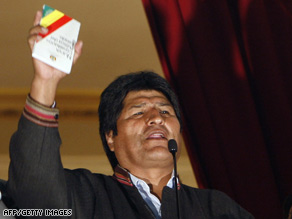 Bolivian President Evo Morales celebrates the first results by holding the new Constitution in La Paz Sunday.