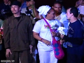 Some of the freed hostages gather for cameras shortly after landing at the Villavicencio Airport Sunday evening.