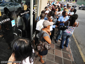 Customers queue outside the Stanford Group-owned Bank of Antigua in St. John's on February 18.