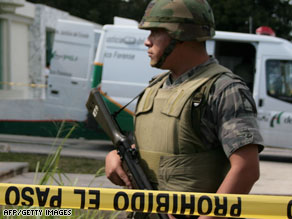 A soldier stands guard outside the forensics service headquarters in Cancun, Mexico, in February.