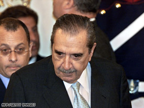 Alfonsin, right, arrives at the house of government in Buenos Aires in January 2002.