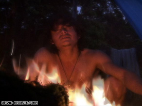 Embera tribesman Raul Mezua sings traditional songs over a campfire in Panama.