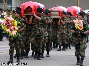 Police in Lima, Peru, carry coffins of officers killed in a November ambush by suspected Shining Path rebels.