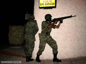 Mexican soldiers hold rifles Saturday during a clash with organized-crime suspects in Acapulco.