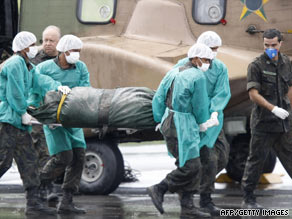 Brazilian military personnel on Tuesday carry the remains of one of the passengers of the Air France crash.