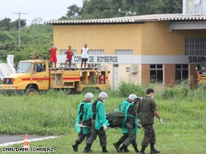 A forensic medical team carries the first of the bodies to be recovered from the Air France flight.