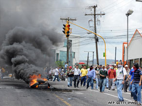 Zelaya's supporters burn tires Monday near the presidential palace in Tegucigalpa.