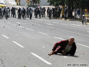 A demonstrator lies in the street during clashes between Zelaya supporters and police in Tegucigalpa on June 29.