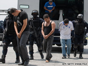 Members of the drug gang La Familia Michoacana
are presented to the media in Mexico City in June.