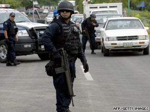Federal policemen stand at a checkpoint in the state of Michoacan last week.