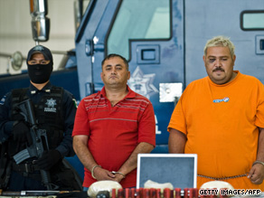 Alleged drug traffickers Miguel Angel Beraza Villa, middle, and Rafael Hernandez face the press Monday.