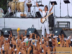 Juanes horses around with Spanish musician and actor Miguel Bose during a soundcheck on Saturday.