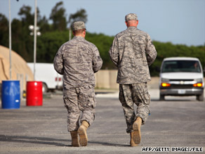 U.S. military personnel walk a road at the U.S. naval base at Guantanamo Bay, Cuba, in July.