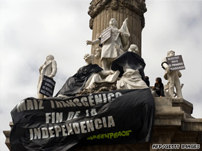 A Greenpeace banner protesting genetically modified corn hangs on a Mexico City monument on Sunday.